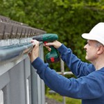 workman-replacing-guttering-on-exterior-of-house