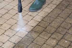 close-up-of-before-&-after-while-power-washing-block-paved-path