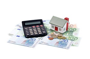 house-&-calculator-on-euro-banknotes-background