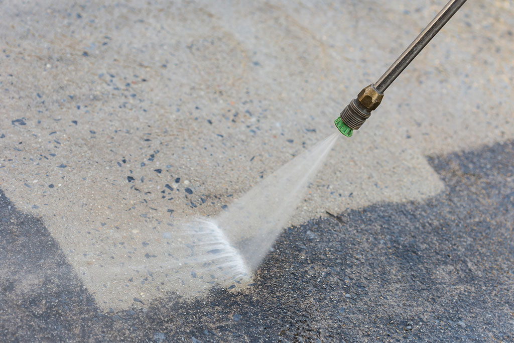 close-up-of-outdoor-cement-floor-cleaning-with-high-pressure-water-jet